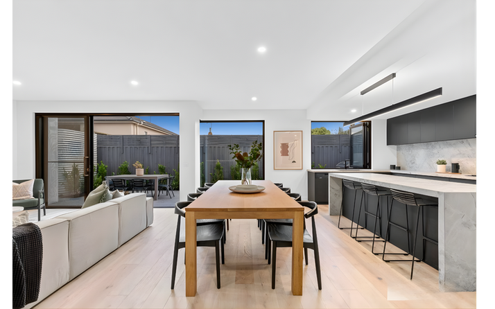 Open-plan dining and kitchen area with outdoor access and modern design