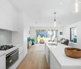 Contemporary kitchen with island bench, white cabinetry and minimalist design