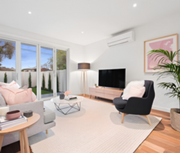 Living room with large windows, natural light and modern seating area