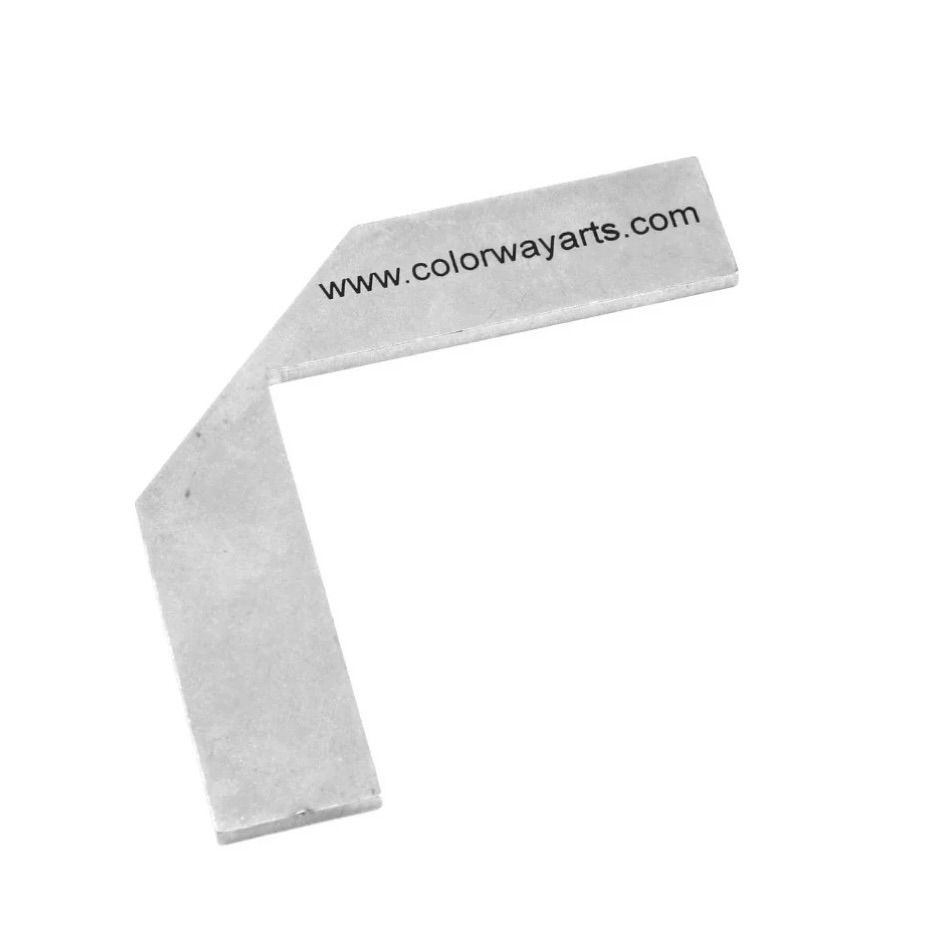 Metal corner miter tool used on book board covered in fabric