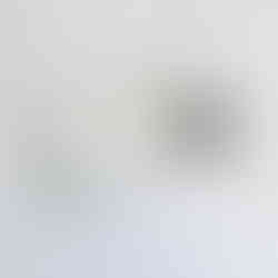 Close-up of Melanie Grant’s custom embossed artist mark pressed into cotton paper on a handmade book