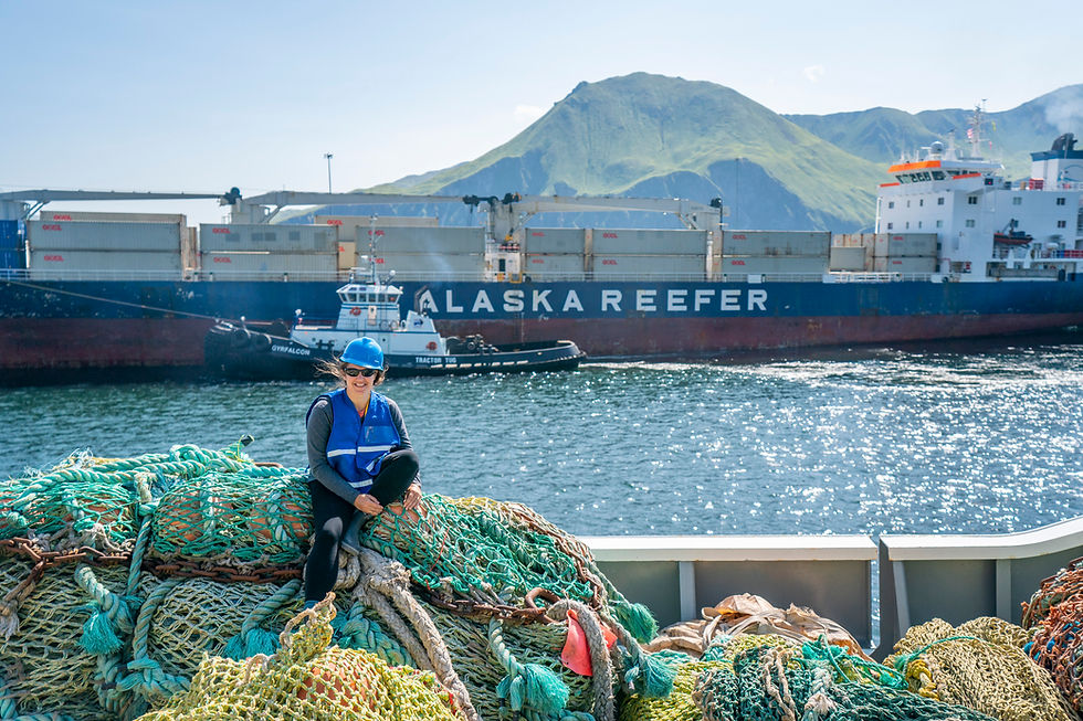 Fishing gear piled up with Alaska mountains in the background