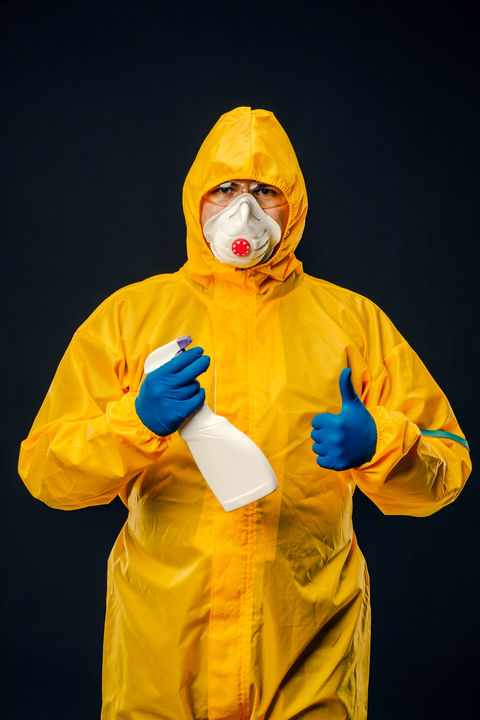 trauma-cleanup-maintenance-worker-protective-yellow-suit-protective-mask-holds-disinfectan