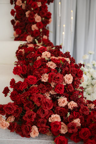 Wedding ceremony arch styling at Braxted Park, Essex: dramatic large-scale red rose floral installation, by Cloud Sixty Events