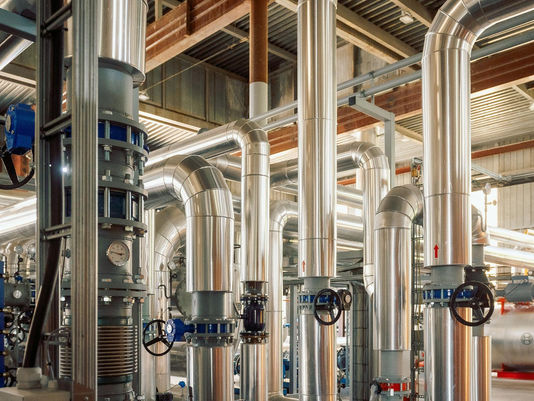 Heat exchangers and insulated pipework in a heat network plant room