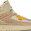 Thumbnail: High-top Air Jordan 2 shoe with beige color and perforated details. BO21 label visible.