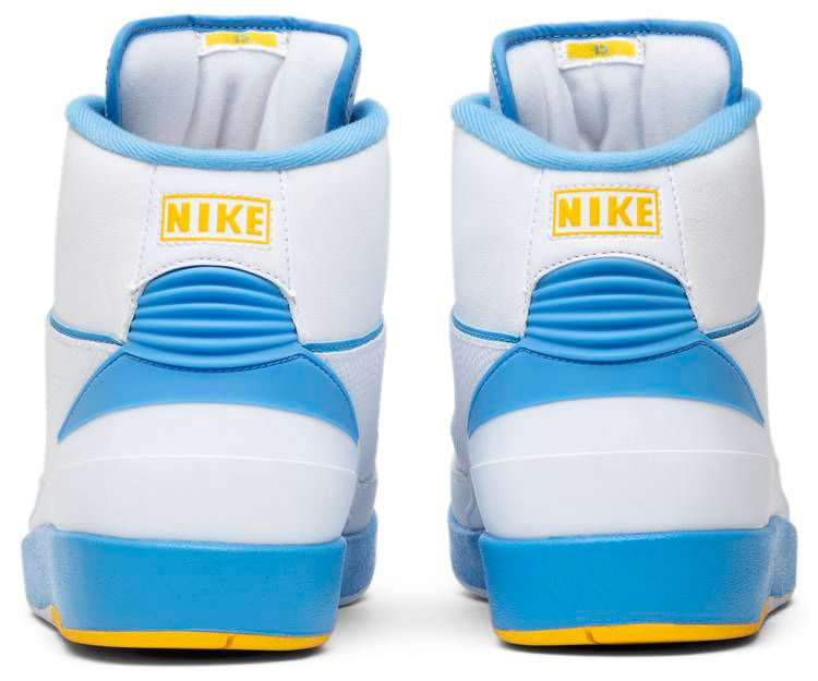 White and blue Nike Air Jordan 2 sneakers with yellow accents