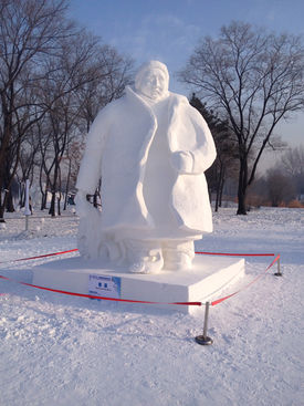 Man in Coat—a snow sculpture of a large man in a thick coat