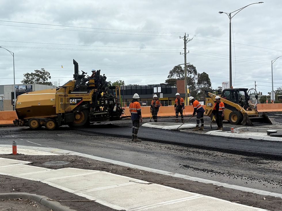 Techash crew laying asphalt with a Caterpiller paver during a road resurfacing project in Seaford, Victoria