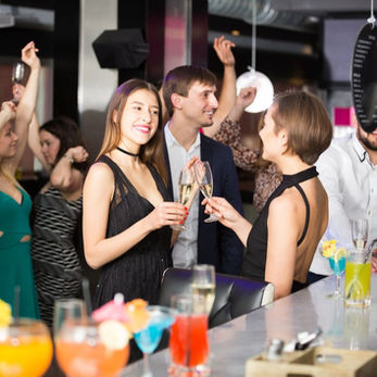 Office party at work, girls sharing a drink together.
