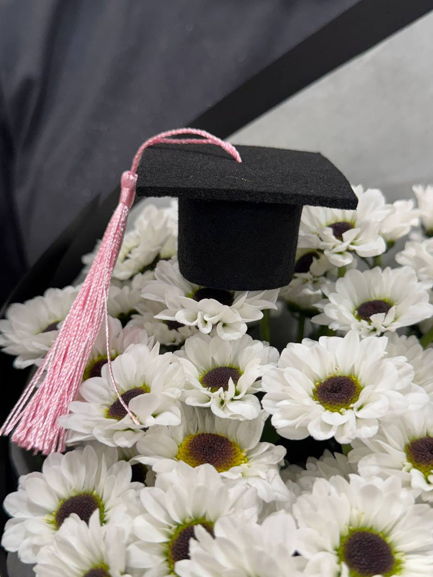 elegant graduation bouquet features bright sunflowers, soft yellow roses and fresh greenery