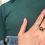 Thumbnail: Brown stone in sterling silver ring on woman's hand wearing a green turtleneck