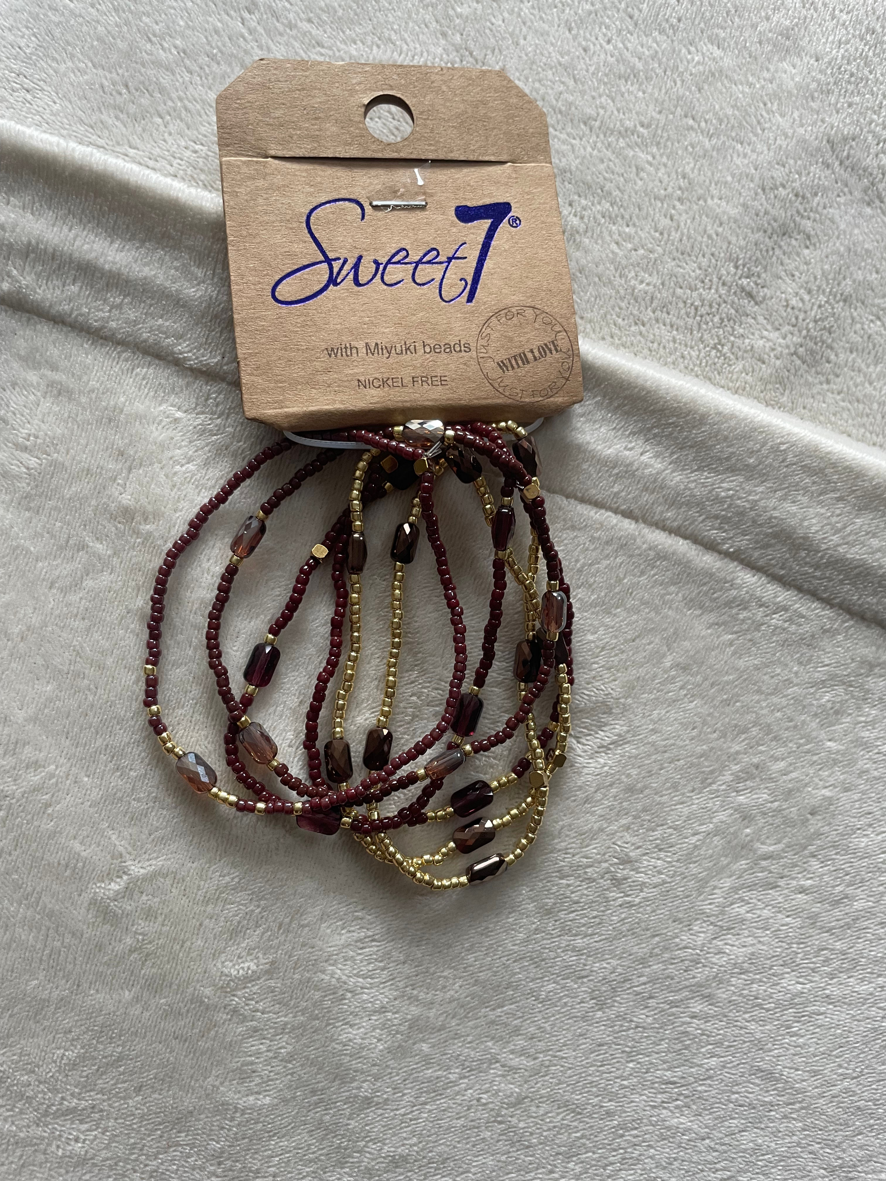 Set van 6 elastische armbandjes donkerbruin_goud