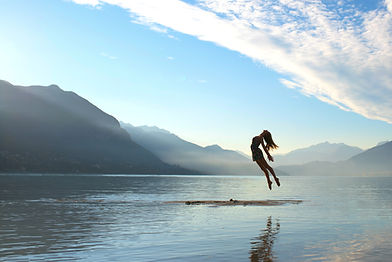 silhouette of jumping woman on raft in middle of lake_edited.jpg