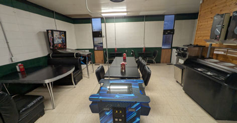 Interior view of a casual dining area with tables and games