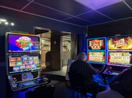 Man playing multiple slot machines