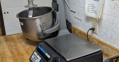 Industrial mixer and scale on wooden counter