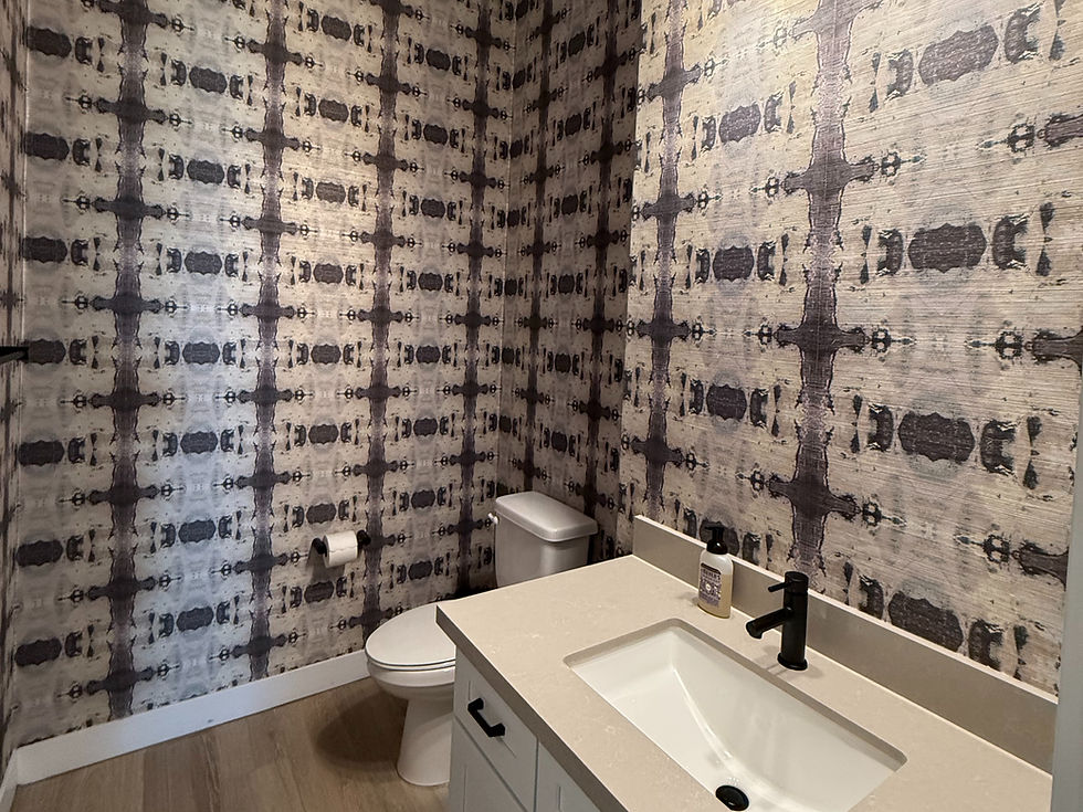 Innovative bathroom design put together byIt Starts Here features striking geometric wallpaper that enhances the modern aesthetic.