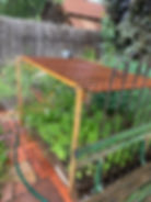 An easy-to-make lattice covered structure provides dappled shade in Lois LaCroix’s vegetable garden.