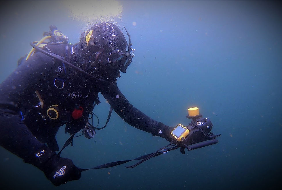 Diver with DiveNET GPS acoustic receiver and display unit under water