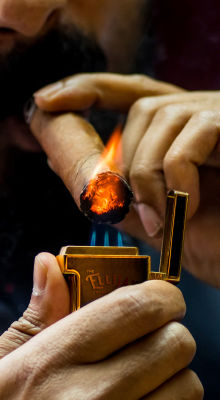The Ellijay lighter lighting a cigar.