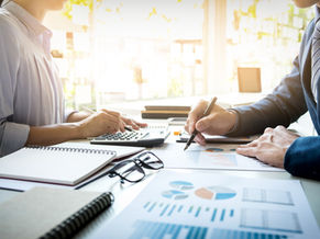 Small business owner reviewing bookkeeping reports and financial statements with a professional bookkeeper
