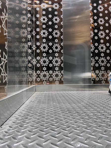 Customised elevator installed at Guleria Kothi, Varanasi, featuring elegant Rose Gold wall panels, durable chequered plate flooring, and a visually refined interior design.