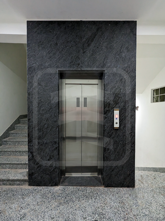 Door panels with small vision of an automatic elevator installed in a residential apartment in Varanasi.