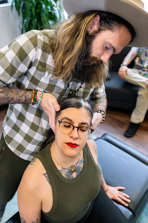 Dr. Chris adjusts a womans neck to relieve tension and headaches. Chiropractic Care Plans offered to provide lasting relief and change patterns.