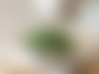 an AI generated image of a bowl of baby spinach on a wood counter top.