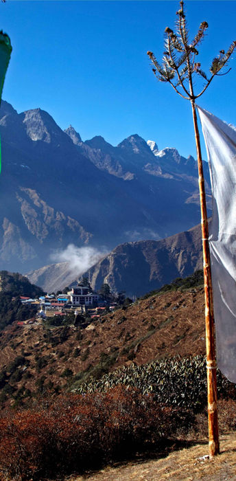 Three prayer flags mountains Tengboche Monastery Nepal Copyright Roger Cracknell Photog