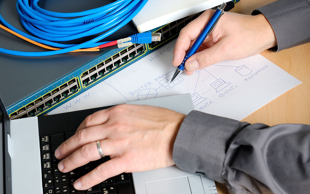 Man Drawing Home Network With Network Switch