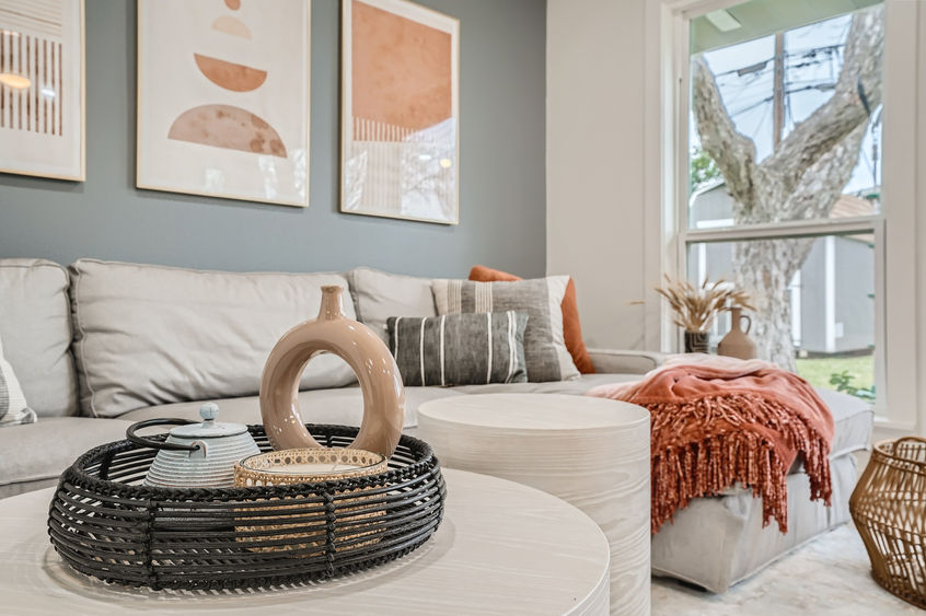 Contemporary living room with a sectional sofa, textured accents, and warm neutral décor.