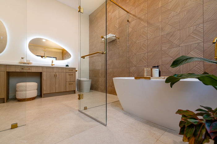 Primary bathroom with freestanding tub, glass shower and custom wood vanity