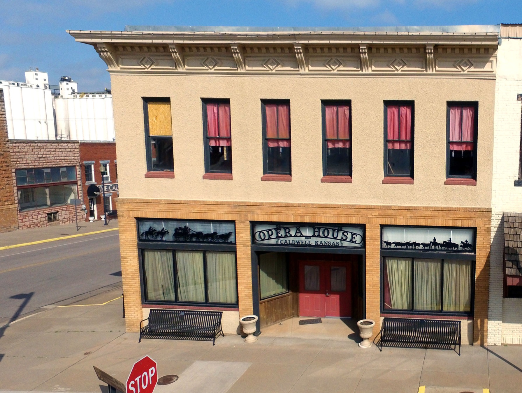 Building with shop fronts and windows, the sign reads