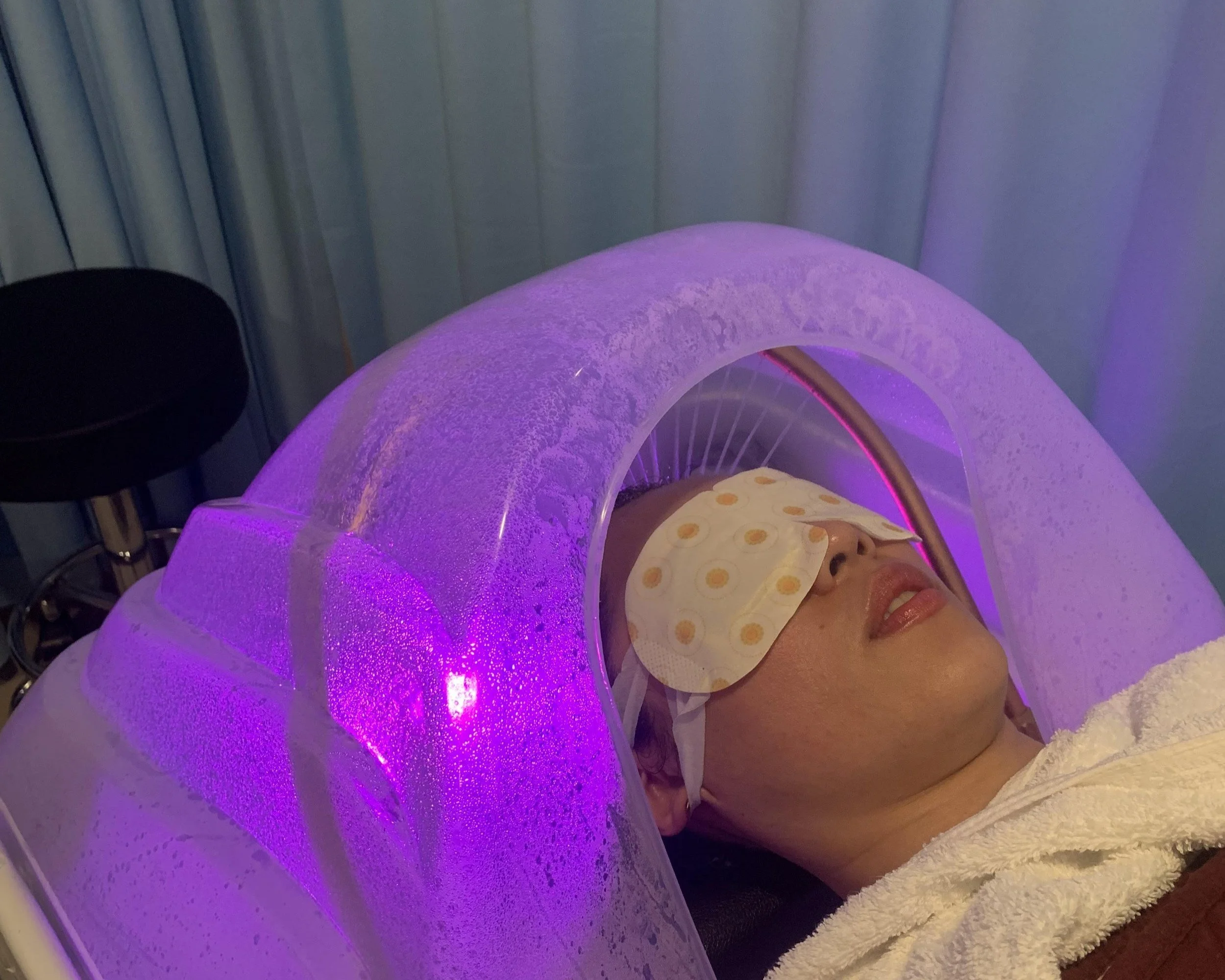 Client receiving a LED light steam treatment