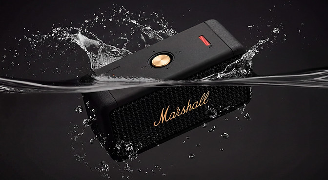 Commercial product photography featuring a Marshall portable speaker with water splash effect