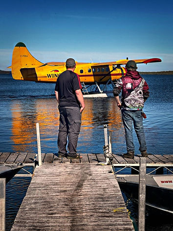 Two people watching a float plane