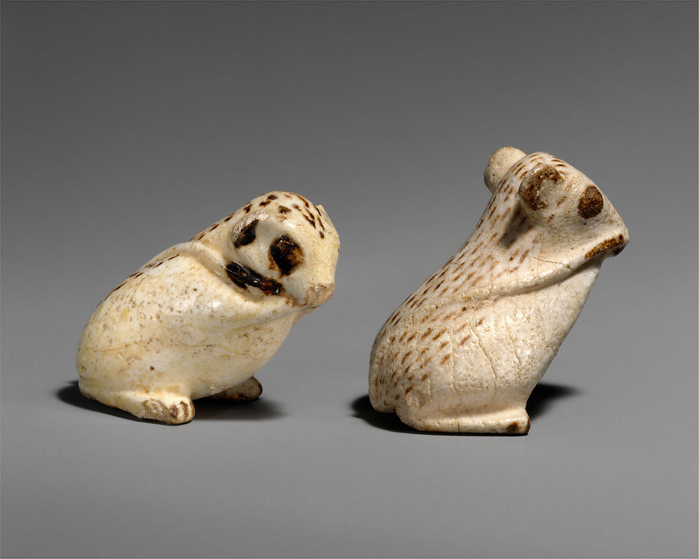 Two small pale faience animal figurines photographed together, including the catalogued jerboa.
