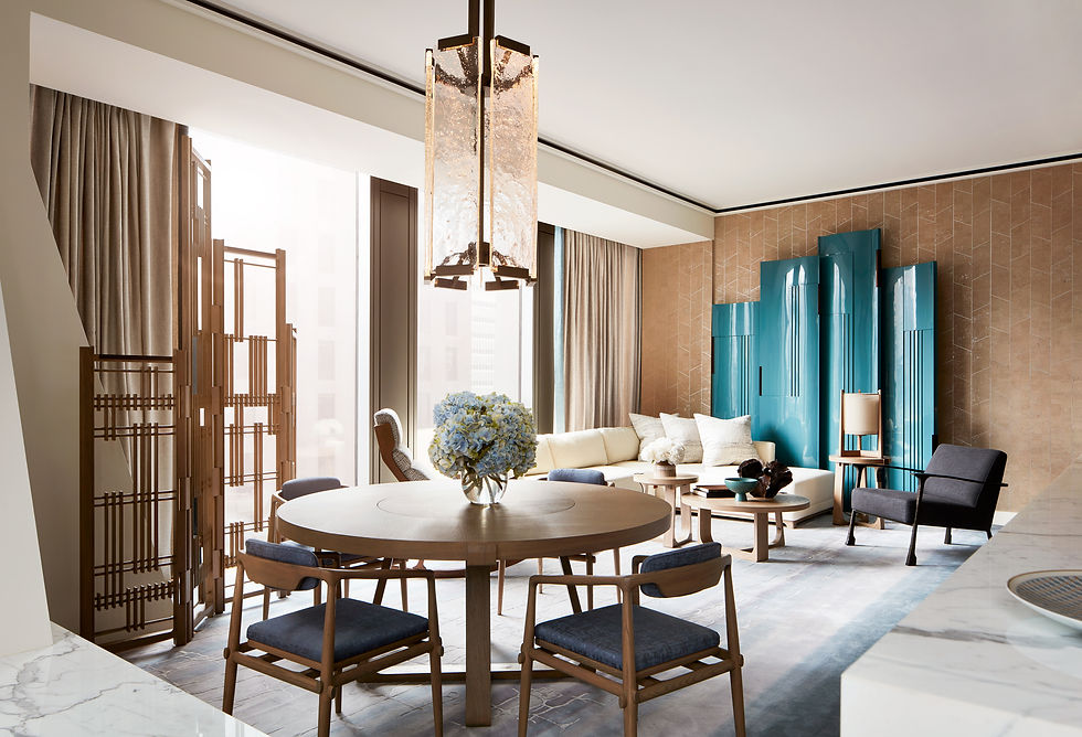 Living and dining room at André Fu’s 53W53 residence, with a round dining table, timber screens and a blue sculptural cabinet.