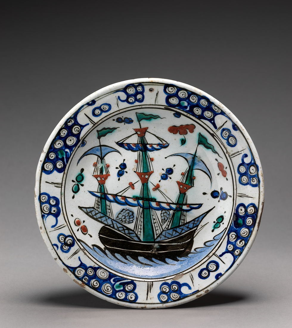 White Iznik dish painted with a sailing ship and surrounded by alternating blue spirals and leaf forms.