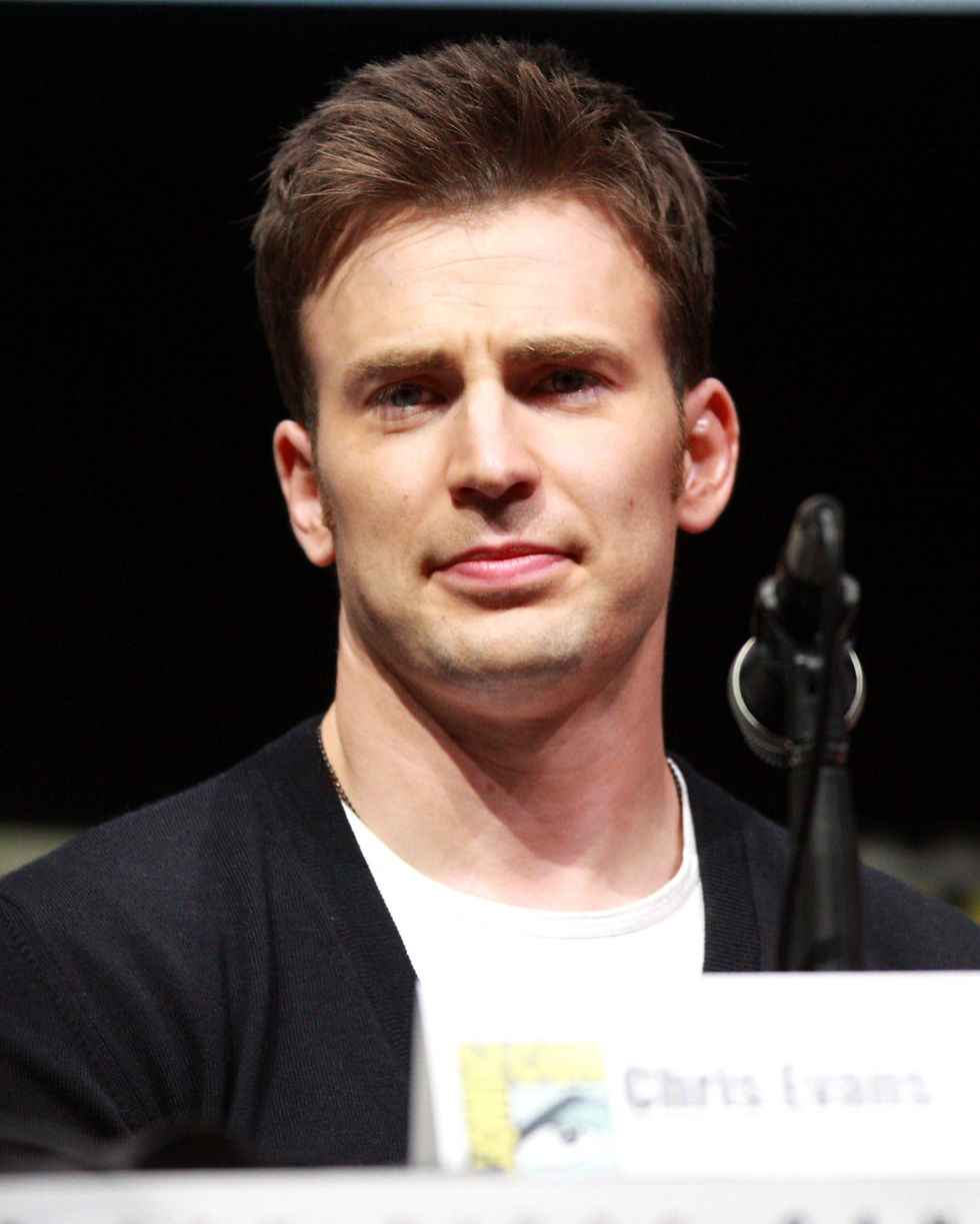 Chris Evans at the 2013 San Diego Comic-Con, wearing a dark cardigan over a white shirt.