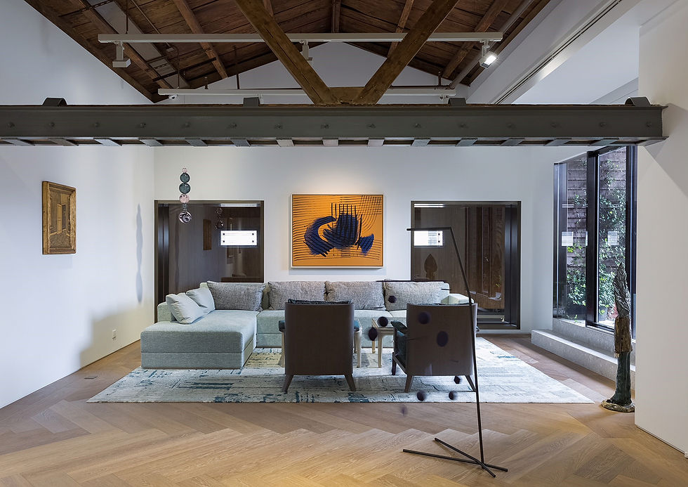 Long empty gallery at Perrotin Shanghai beneath timber roof beams, skylights and exhibition lighting.