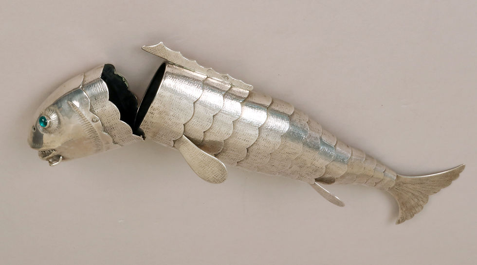 Silver fish-shaped spice container with its head lifted away from the body.
