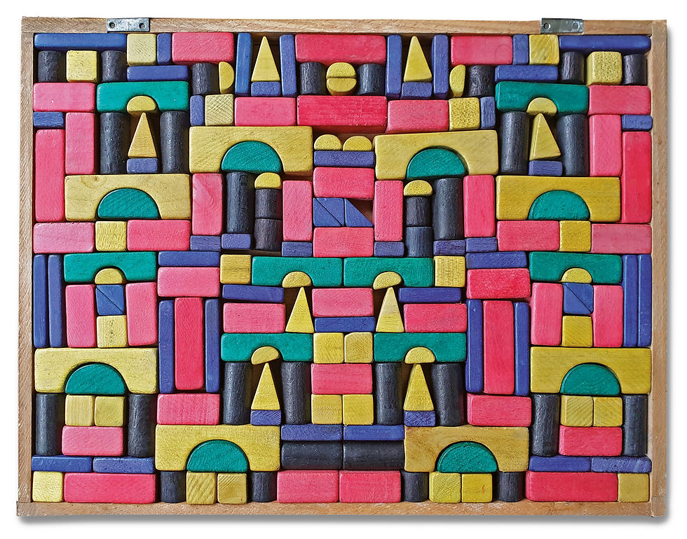 An open wooden box filled with red, yellow, blue and green Les Bois de Megève building blocks.
