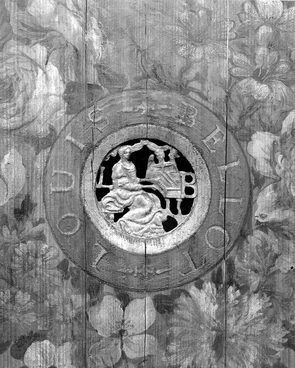 Black-and-white detail of a pierced rosette surrounded by painted flowers on a harpsichord soundboard.