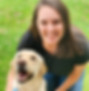 Alexis sitting in grass with a Yellow Labrador Retriever