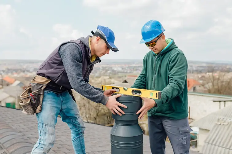 two professional installing chimney