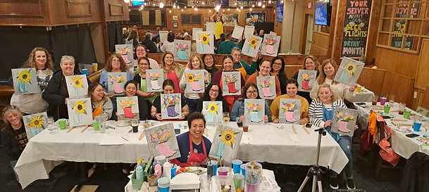 Guests gathered at a creative group painting session hosted by The Funky Brush and Palette.