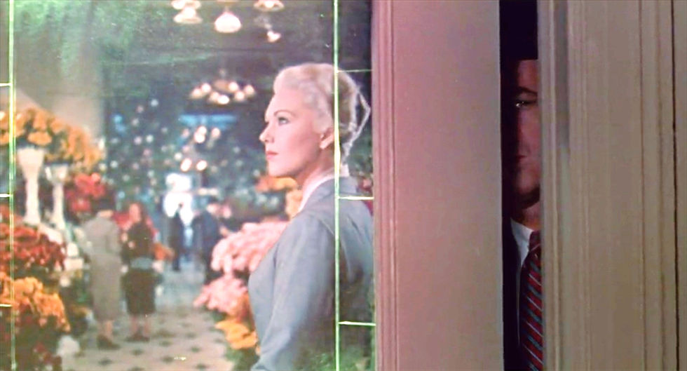James Jimmy Stewart spy shadows peeks through door crack at Kim Novak in Alfred Hitchcock's classic psychological romantic suspense thriller “Vertigo”